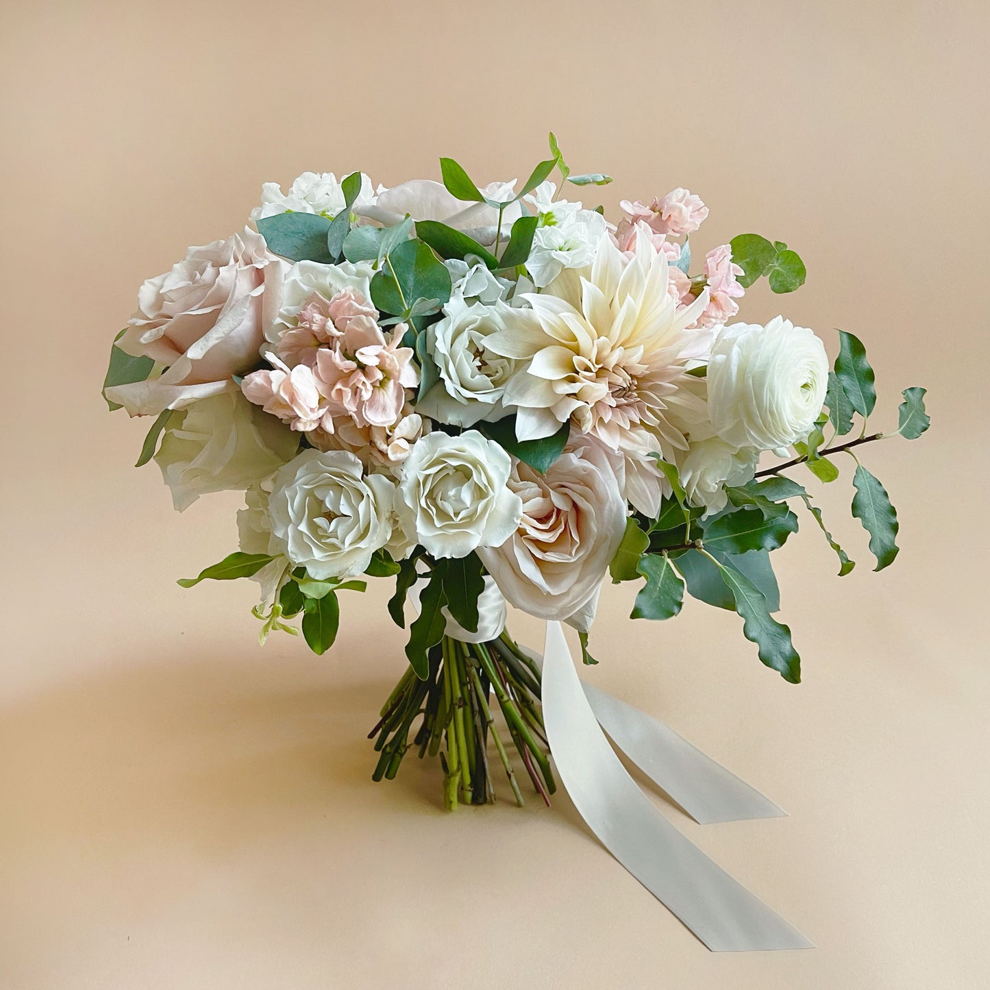 Full shot, Soft white and pink flowers. Attendant bouquet, bridesmaid bouquet, posy-style bouquets for bridesmaids. They emphasize blooms over greenery, are hand-tied & finished with a ribbon of your choice, and come in a vase. From the best wedding florist in Toronto Quince Flowers.