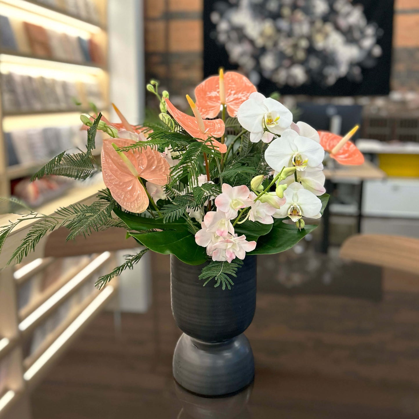 Small entrance flower arrangement on a workplace countertop, workplace weeklies for B2B flowers in Toronto, Quince Flowers – Toronto’s best florist, available near you.