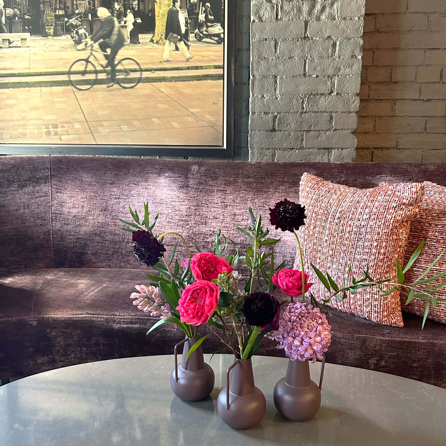 Bright pink, medium pink and dark red flowers. Workplace mini small tabletop arrangement – for a workplace countertop, workplace weeklies for B2B flowers in Toronto, Quince Flowers – Toronto’s best B2B florist, available near you.