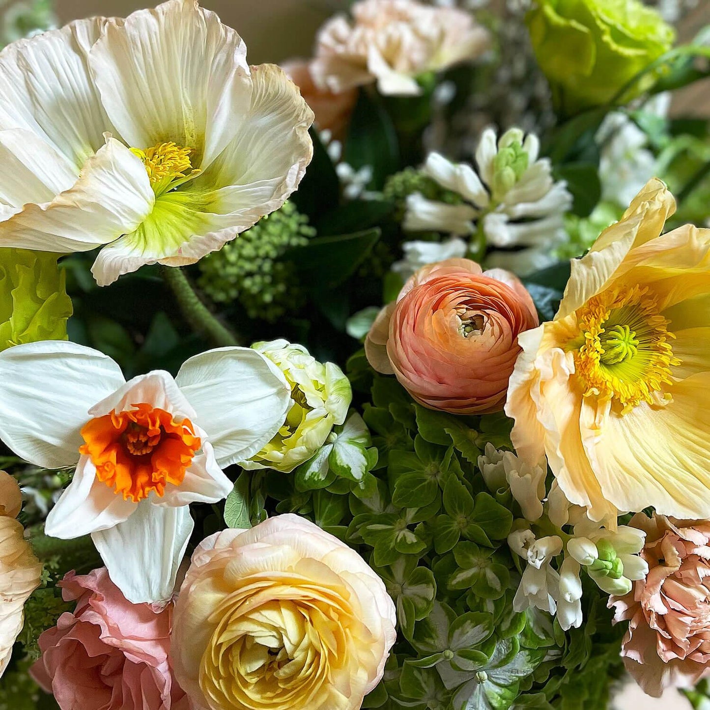 Image of citrus-inspired flowers in sunshine-filled lime, grapefruit, and tangerine hues, complemented by soft apricots and nudes. Order online for same-day flower delivery from Toronto's best florist, available near you.