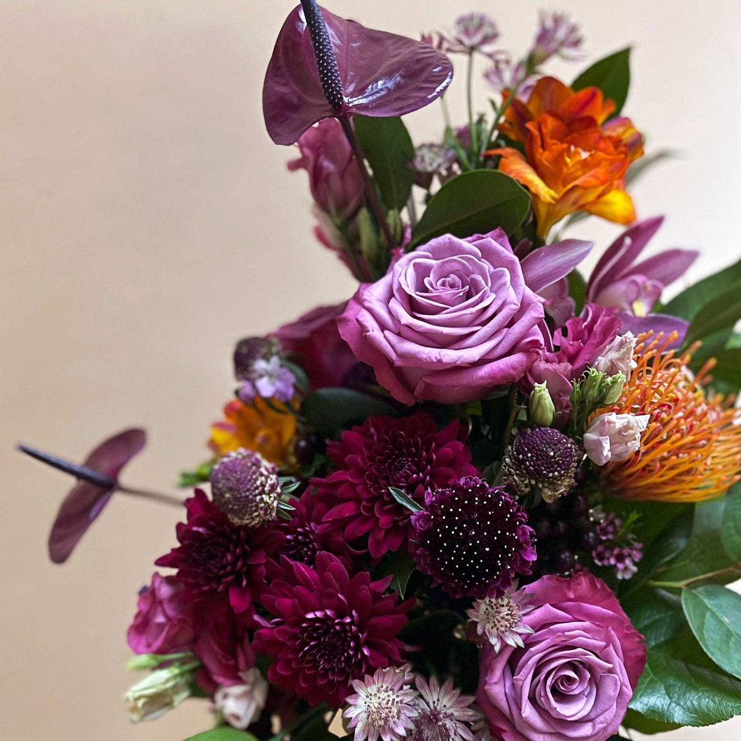 Close-up image of a dynamic bouquet starting with yellows, deepening to lavender and purple, with a touch of acid green for energy. Order online for same-day flower delivery from Toronto's best florist, available near you.