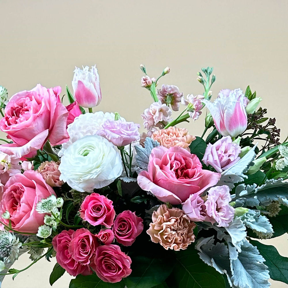 
                      
                        Close-up Image of a bouquet featuring airy pastel pink and delicate cream flowers, including a mix of white and pink roses, blush ranunculus, lisianthus, and carnations. Celebrate gender non-binary expression with this sweet palette. Order online for same-day flower delivery from Toronto's best florist, available near you.
                      
                    