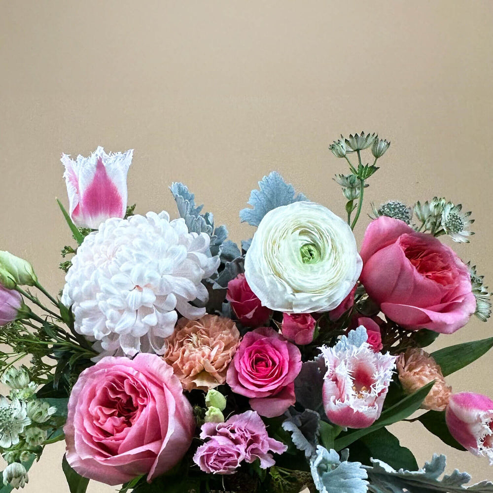 
                      
                        Close-up Image of a bouquet featuring airy pastel pink and delicate cream flowers, including a mix of white and pink roses, blush ranunculus, lisianthus, and carnations. Celebrate gender non-binary expression with this sweet palette. Order online for same-day flower delivery from Toronto's best florist, available near you.
                      
                    