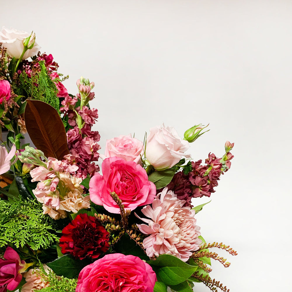 Close-up Image of a bouquet featuring punchy magenta, burgundy, blush, and wintergreens, creating a cozy and gender non-binary color story.Order online for same-day flower delivery from the best florist in Toronto near you.