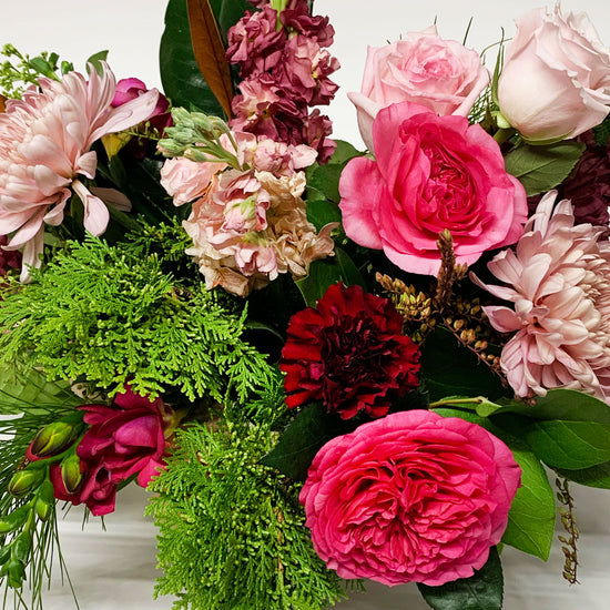 Close-up Image of a bouquet featuring punchy magenta, burgundy, blush, and wintergreens, creating a cozy and gender non-binary color story.Order online for same-day flower delivery from the best florist in Toronto near you.