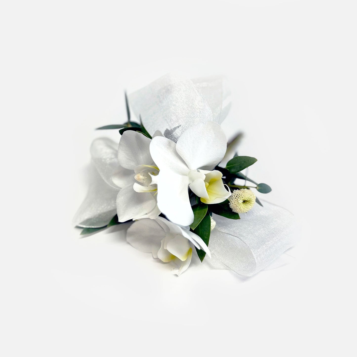 White orchid Corsage – It can be pinned on a woman's clothing, attached with magnets, or worn on the wrist. We like the modern look of a single large, elegant flower like an orchid bloom or garden rose. A cluster of smaller flowers also works! From the best wedding florist in Toronto Quince Flowers.