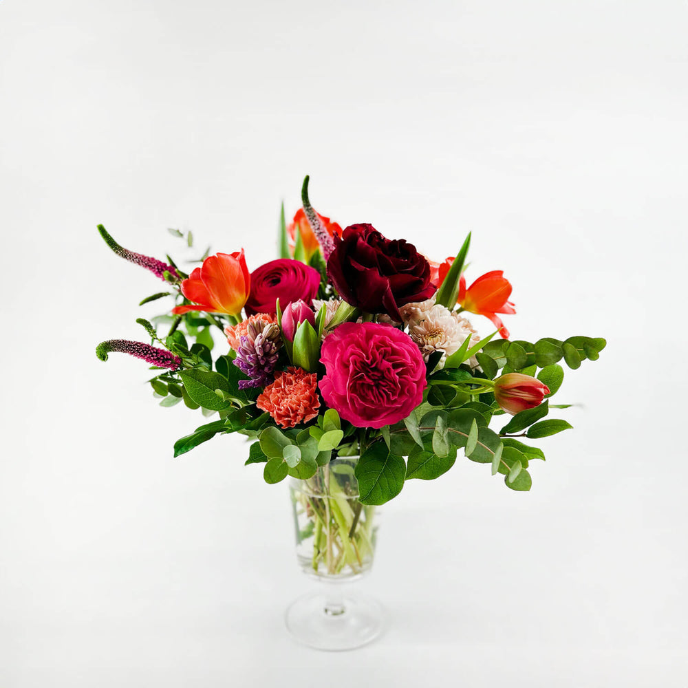 
                      
                        Image of a daring bouquet featuring spring flowers and roses, including hyacinth, tulips, hot pink ranunculus, veronica, lisianthus, and blush hydrangea. Order online for same-day flower delivery from Toronto's best florist, available near you.
                      
                    