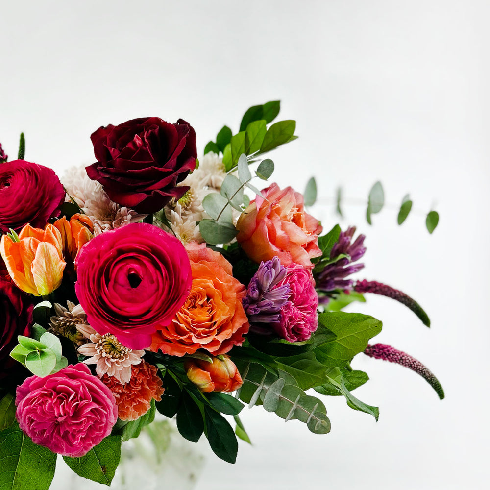 
                      
                        Close-up Image of a daring bouquet featuring spring flowers and roses, including hyacinth, tulips, hot pink ranunculus, veronica, lisianthus, and blush hydrangea. Order online for same-day flower delivery from Toronto's best florist, available near you.
                      
                    