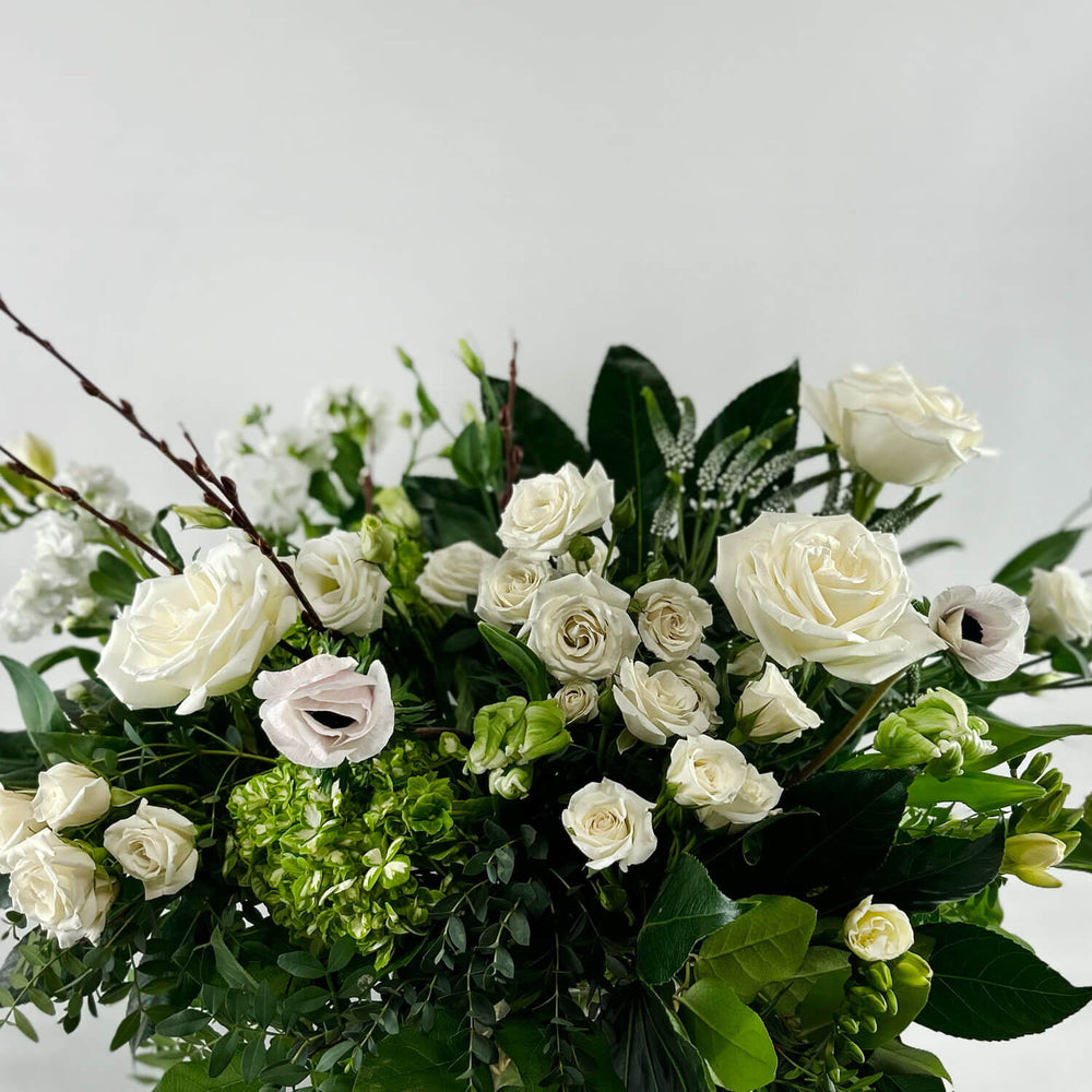 
                      
                        Close-up Image of a romantic bouquet featuring cream and white flowers, including garden roses, parrot tulips, freesia, and ranunculus. Order online for same-day flower delivery from Toronto's best florist, available near you.
                      
                    