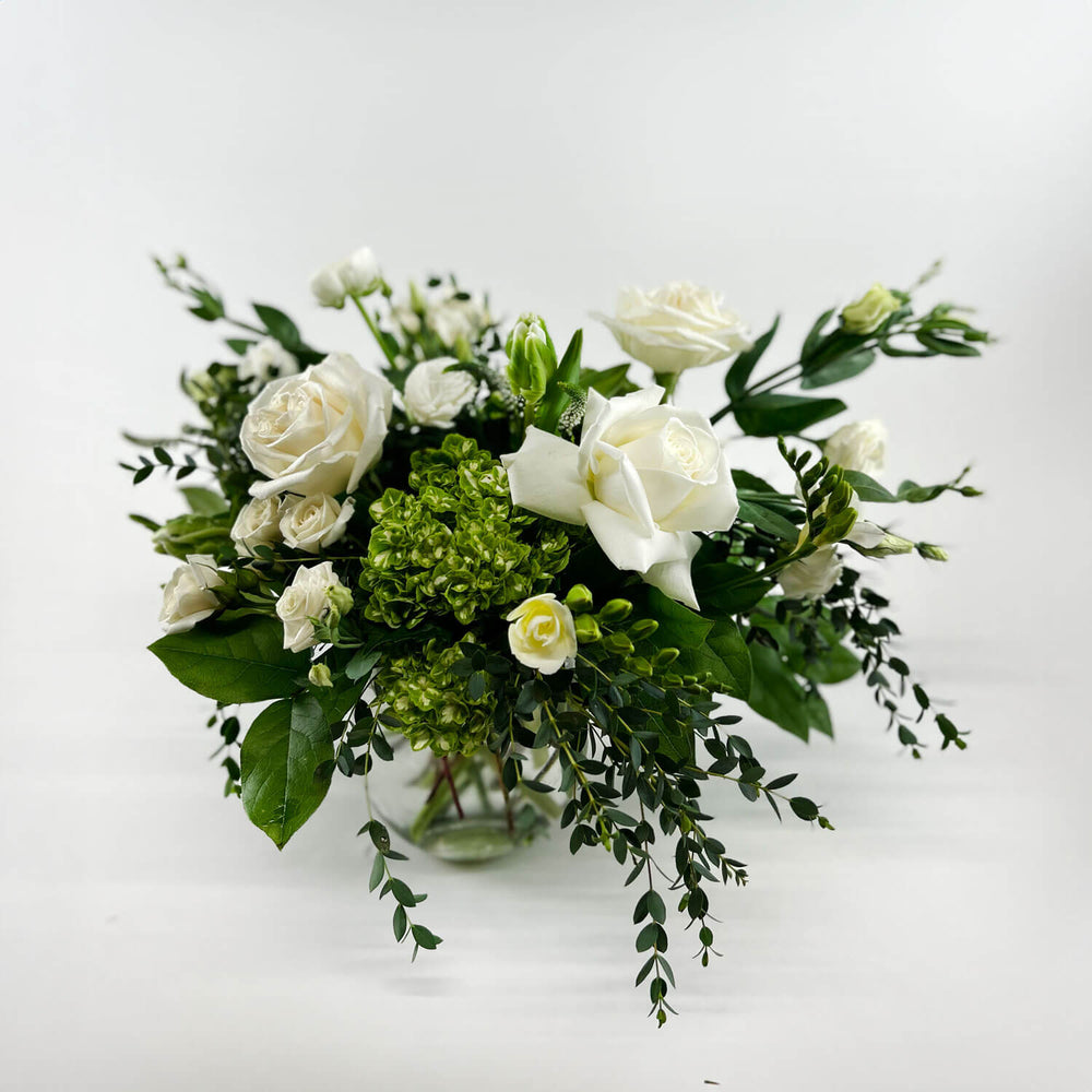 
                      
                        Image of a romantic bouquet featuring cream and white flowers, including garden roses, parrot tulips, freesia, and ranunculus. Order online for same-day flower delivery from Toronto's best florist, available near you.
                      
                    