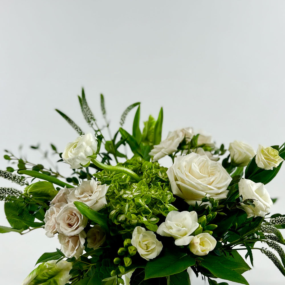 
                      
                        Close-up Image of a romantic bouquet featuring cream and white flowers, including garden roses, parrot tulips, freesia, and ranunculus. Order online for same-day flower delivery from Toronto's best florist, available near you.
                      
                    