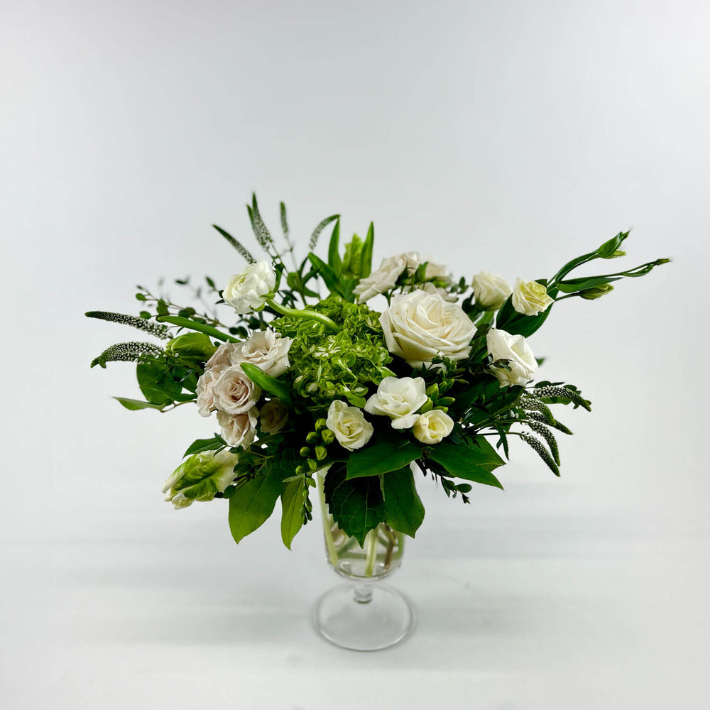 
                      
                        Image of a romantic bouquet featuring cream and white flowers, including garden roses, parrot tulips, freesia, and ranunculus. Order online for same-day flower delivery from Toronto's best florist, available near you.
                      
                    