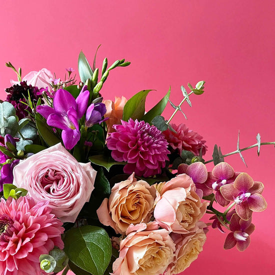 Close-up image of a bouquet featuring radiant colors including pink, orange, and pongee flowers, creating a daring and inspired palette.  Order online for same-day flower delivery from Toronto's best florist, available near you.