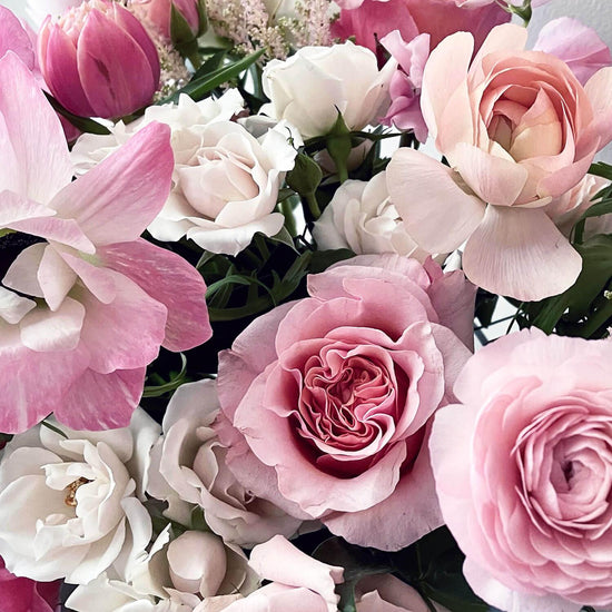Close-up image of airy pastel pink and delicate cream flowers, evoking a sweet and gender non-binary color story. Order online for same-day flower delivery from Toronto's best florist, available near you.