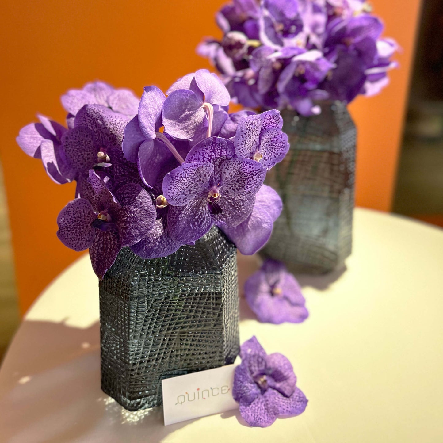 Large purple orchid tabletop arrangement – for a workplace countertop, workplace weeklies for B2B flowers in Toronto, Quince Flowers – Toronto’s best B2B florist, available near you.