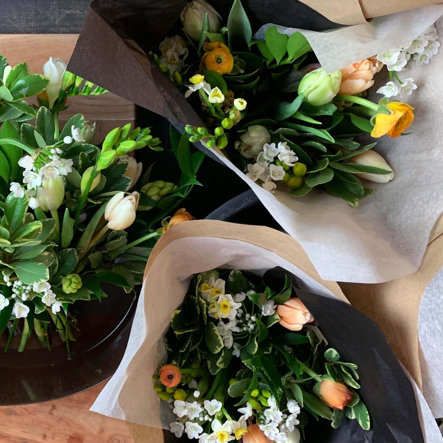 Wonderblooms monthly flower subscription from Quince Flowers, Toronto Florist and flower delivery - bouquets shot from above with tulips, yellows and light pinks. Order online for flower & plant subscriptions from the best florist in Toronto near you.