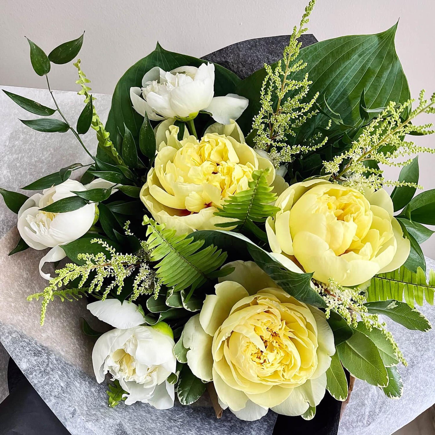 Wonderblooms monthly flower subscription from Quince Flowers, Toronto Florist and flower delivery - yellow and white peonies with beautiful green foliage. Order online for flower & plant subscriptions from the best florist in Toronto near you.