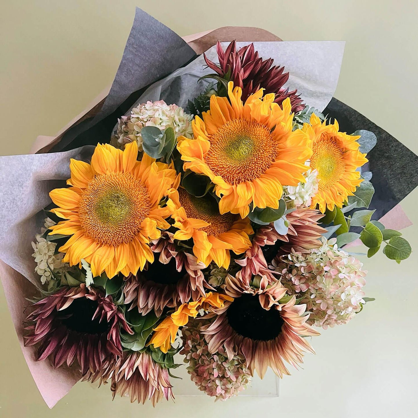 Wonderblooms monthly flower subscription from Quince Flowers, Toronto Florist and flower delivery - sunflowers in dark purple and bright gold. Order online for flower & plant subscriptions from the best florist in Toronto near you.