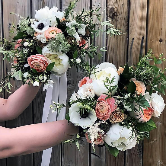 A person is holding two beautiful bouquets of flowers against a wooden background.Order online for wedding & event flowers from the best florist in Toronto near you.