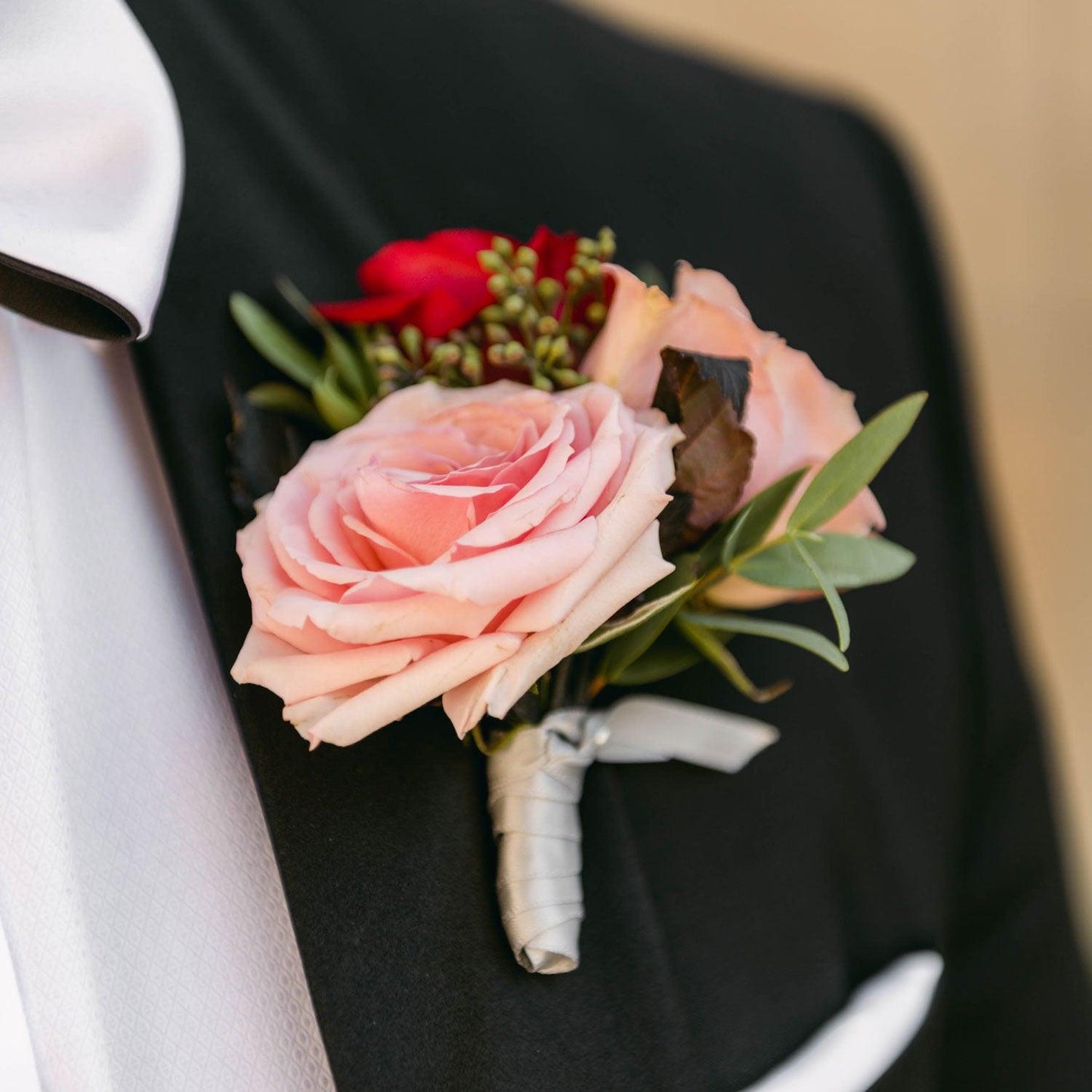 Elegant boutonniere made of pink flowers and green leaves, Order online for wedding & event flowers from the best florist in Toronto near you.
