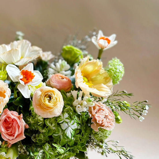 Image of citrus-inspired flowers in sunshine-filled lime, grapefruit, and tangerine hues, complemented by soft apricots and nudes. Order online for same-day flower delivery from Toronto's best florist, available near you.