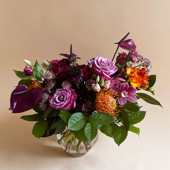 Load image into Gallery viewer, Image of a dynamic bouquet starting with yellows, deepening to lavender and purple, with a touch of acid green for energy. Order online for same-day flower delivery from Toronto&amp;#39;s best florist, available near you.
