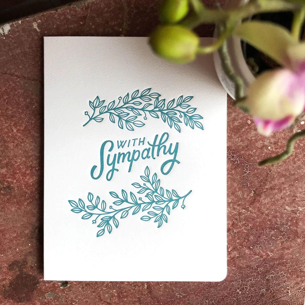 
                      
                        A sympathy card with teal lettering and leaf designs on a white background.Order online for event items from the best florist in Toronto near you.
                      
                    